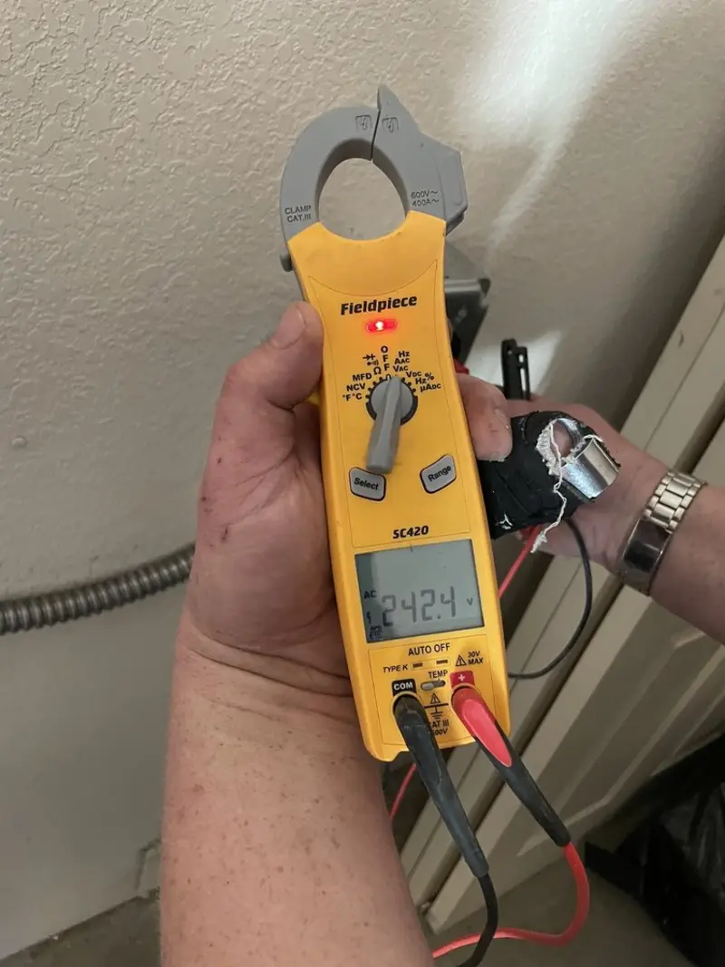 Voltage testing with clamp meter during Ceiling Fan Installation in Natchez